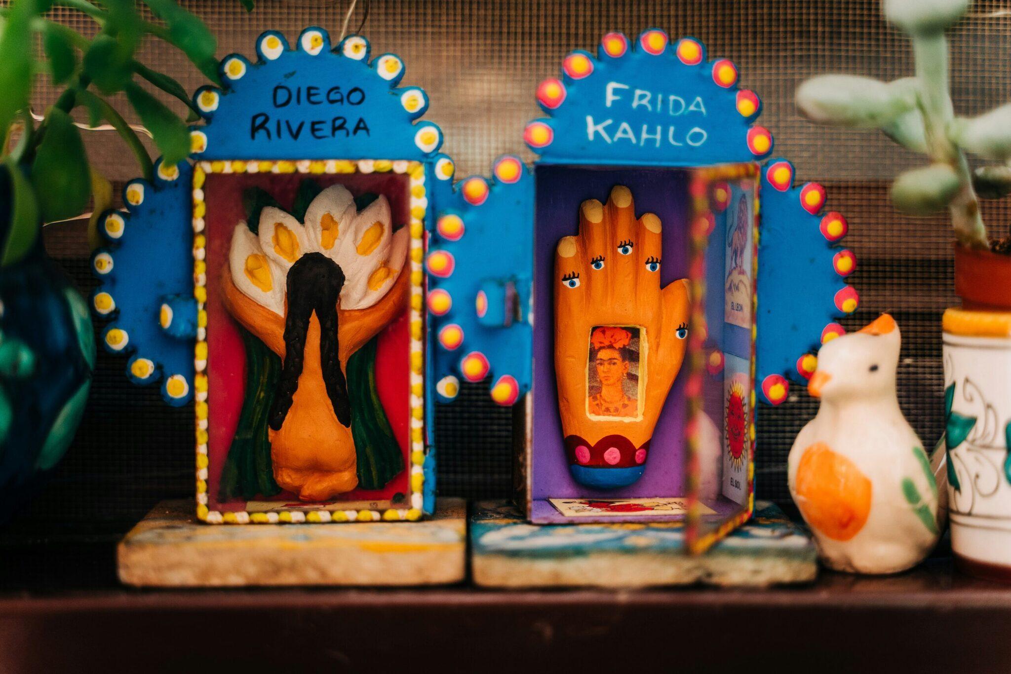 Deux autels mexicains colorés décorés de lumières, présentant des motifs et symboles traditionnels inspirés par Diego Rivera et Frida Kahlo
