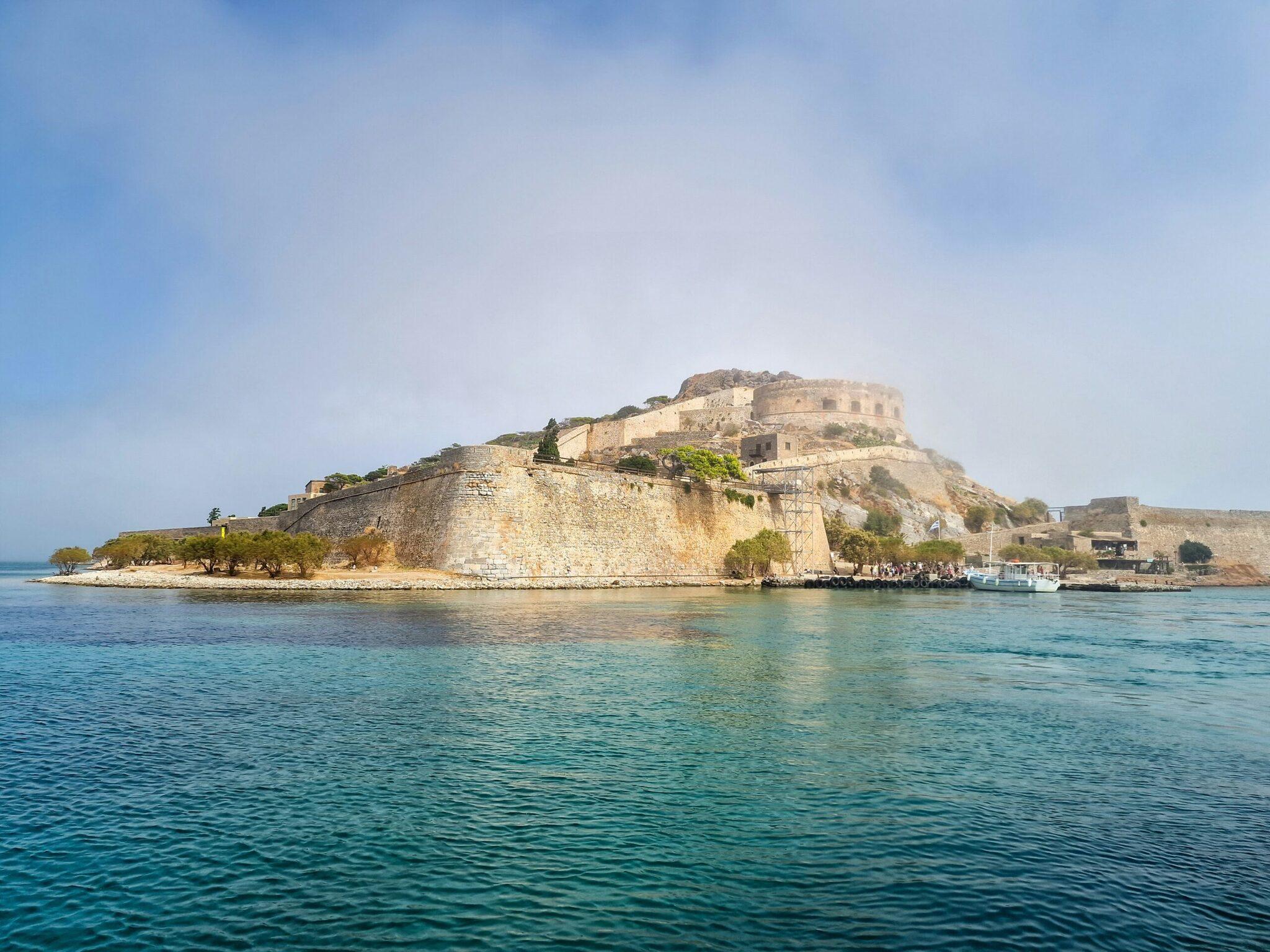 Venetian fortress on a rocky peninsula surrounded by turquoise sea in Crete
